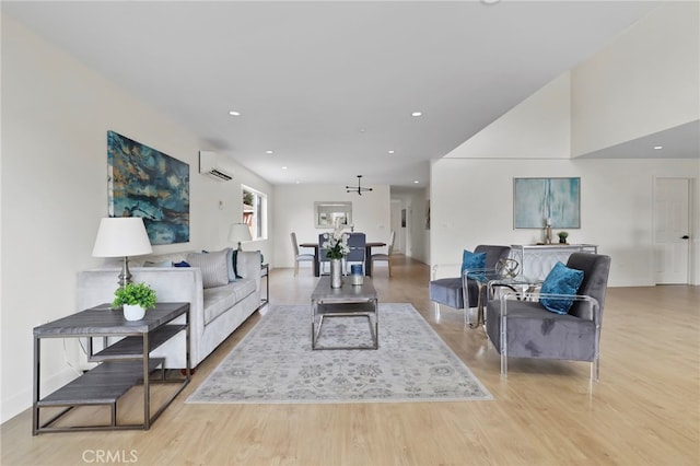 living room with light wood-type flooring and a wall unit AC