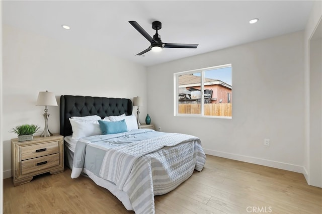 bedroom with ceiling fan and light hardwood / wood-style flooring