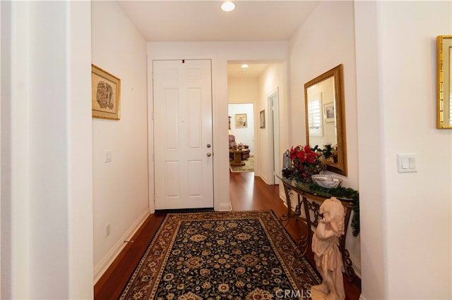 hallway with dark hardwood / wood-style flooring