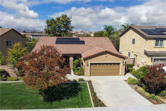 view of front facade featuring a front yard and solar panels