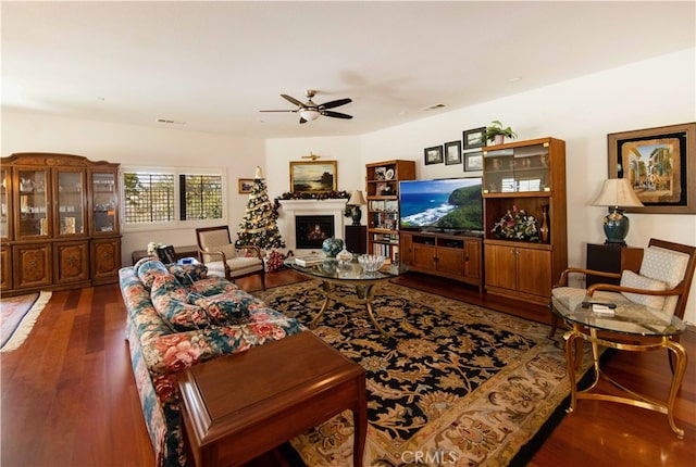 living room featuring wood-type flooring and ceiling fan