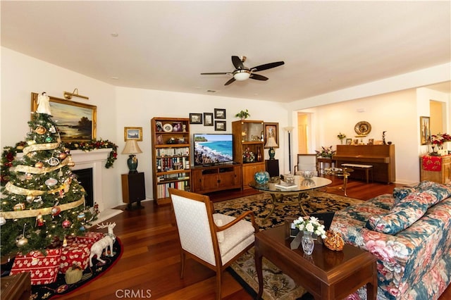 living room featuring ceiling fan and dark hardwood / wood-style floors