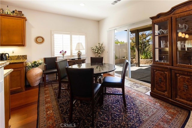 dining area featuring dark wood-type flooring