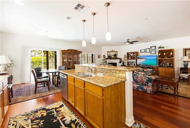 kitchen with dishwasher, light stone counters, dark hardwood / wood-style floors, sink, and ceiling fan