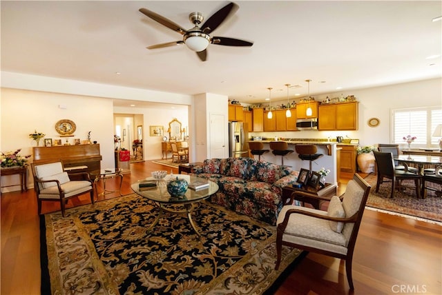 living room featuring ceiling fan and hardwood / wood-style floors