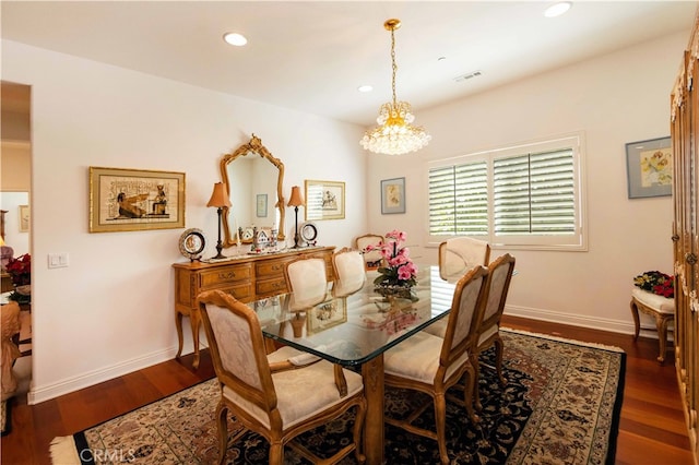 dining room with a notable chandelier and dark wood-type flooring