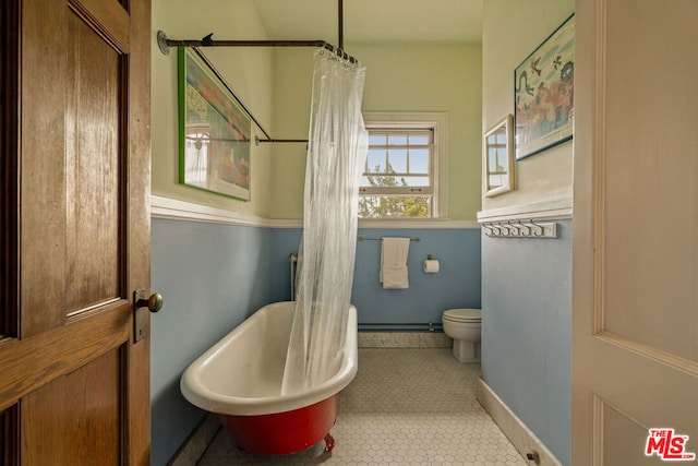 bathroom with a bathing tub, toilet, and tile patterned floors