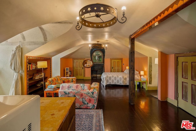 bedroom featuring vaulted ceiling and dark hardwood / wood-style flooring