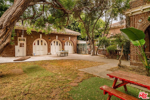 exterior space featuring a lawn and a patio area