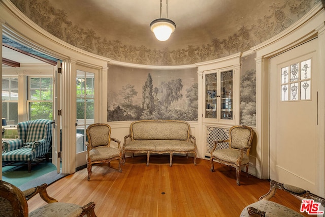 sitting room with a healthy amount of sunlight and hardwood / wood-style floors