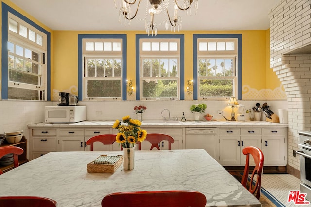 dining room with an inviting chandelier and sink