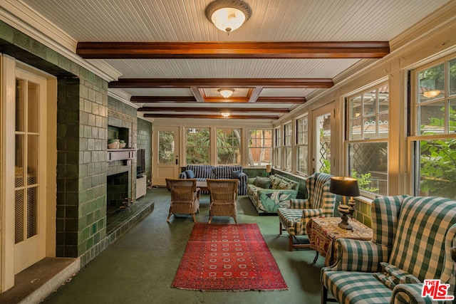 sunroom featuring a fireplace and beam ceiling