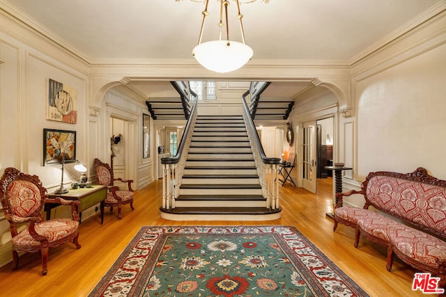 interior space featuring light wood-type flooring and crown molding