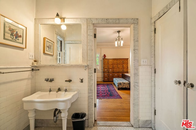 bathroom with tile walls and hardwood / wood-style floors