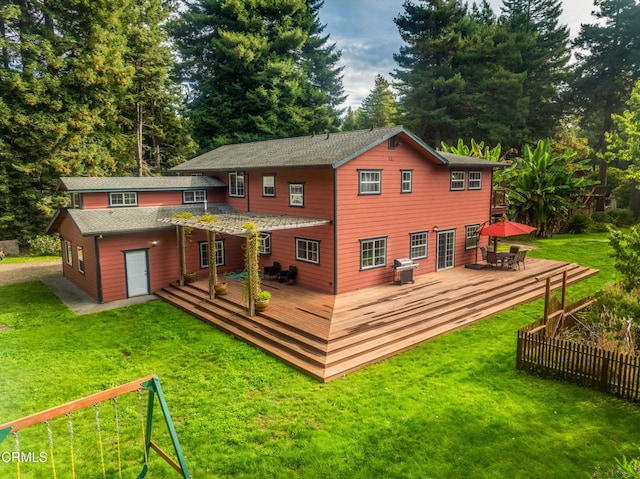 back of property featuring a wooden deck and a yard