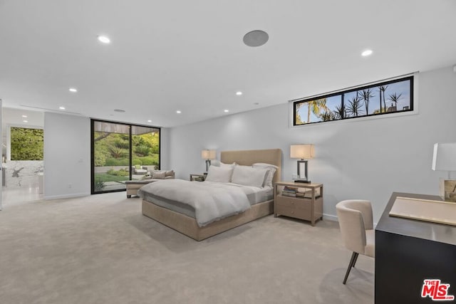 carpeted bedroom featuring access to exterior and expansive windows