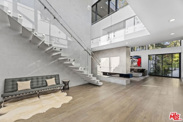 interior space featuring hardwood / wood-style floors and a towering ceiling