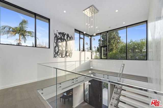 interior space with a chandelier, hardwood / wood-style flooring, and decorative light fixtures