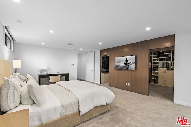 carpeted bedroom with a closet and a walk in closet