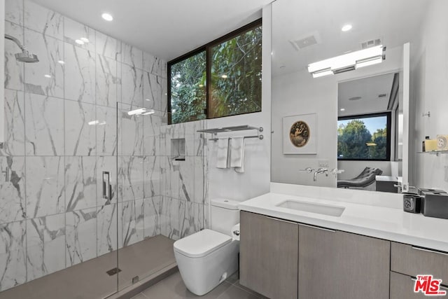 bathroom featuring vanity, toilet, tile patterned floors, and a shower with shower door