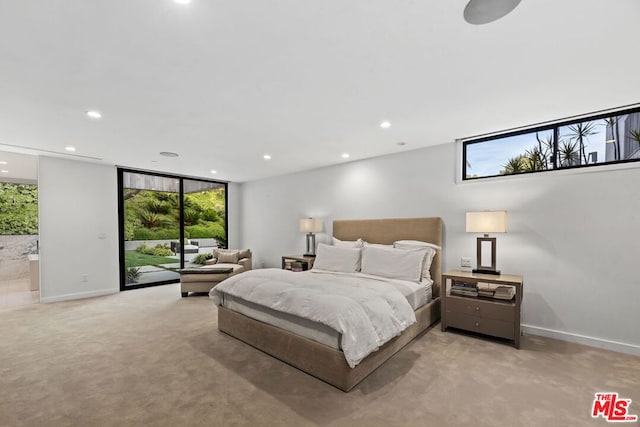 bedroom with light carpet, expansive windows, and access to outside