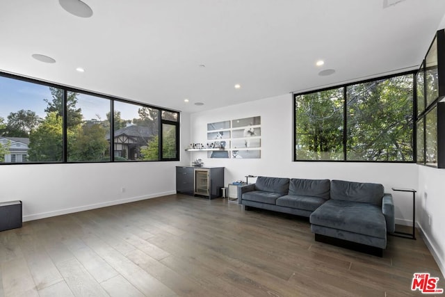 living room featuring wine cooler and dark hardwood / wood-style flooring