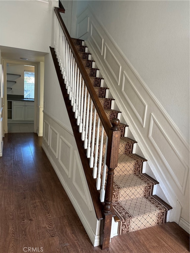 staircase with hardwood / wood-style floors