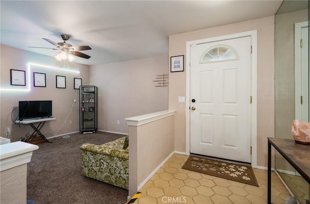 entrance foyer featuring ceiling fan and light carpet