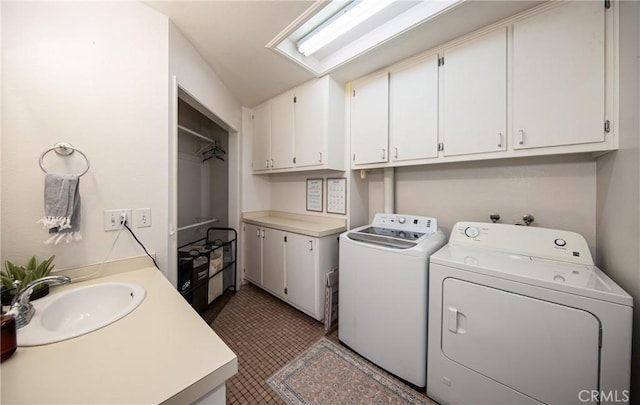 laundry area with tile patterned flooring, washer and clothes dryer, and sink