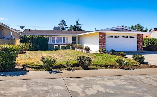 ranch-style home with a garage and a front lawn