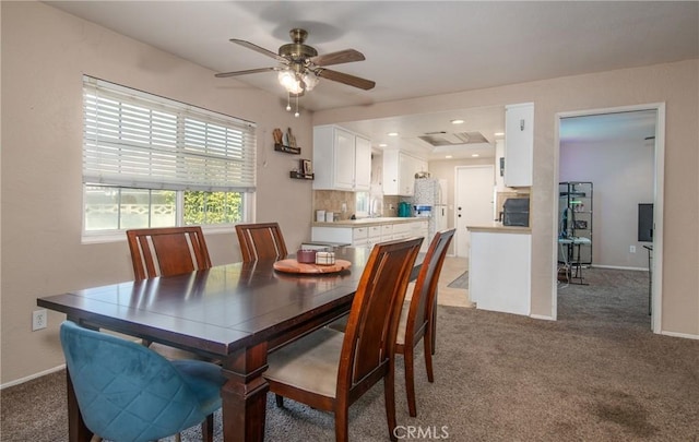 dining room with ceiling fan and dark carpet