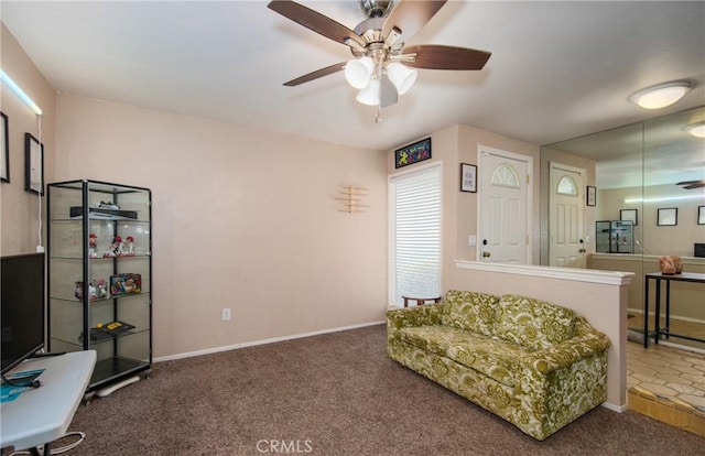 sitting room with ceiling fan and carpet floors