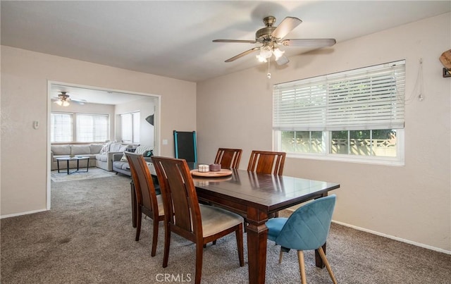 carpeted dining space featuring ceiling fan