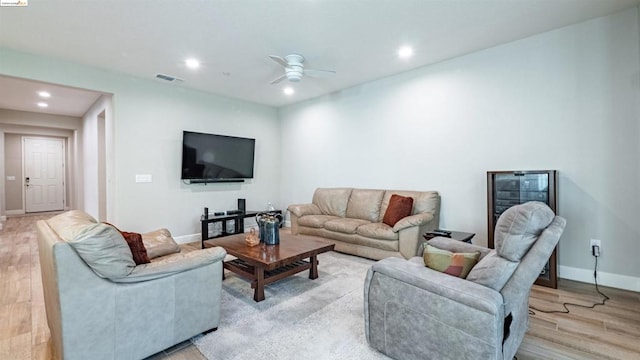 living room featuring light hardwood / wood-style floors and ceiling fan