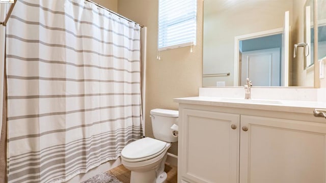 bathroom featuring vanity, toilet, and a shower with shower curtain