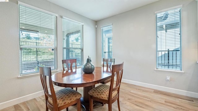 dining space with light hardwood / wood-style flooring and a wealth of natural light