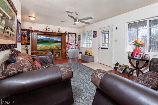 living room with light hardwood / wood-style floors and ceiling fan