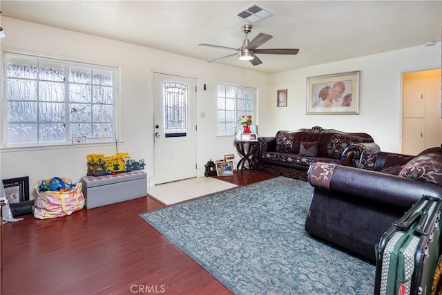 living room with dark hardwood / wood-style floors and ceiling fan