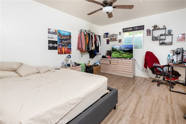 bedroom with light hardwood / wood-style floors and ceiling fan