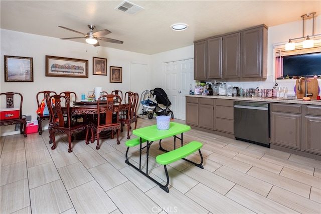 kitchen featuring sink, ceiling fan, decorative light fixtures, and stainless steel dishwasher