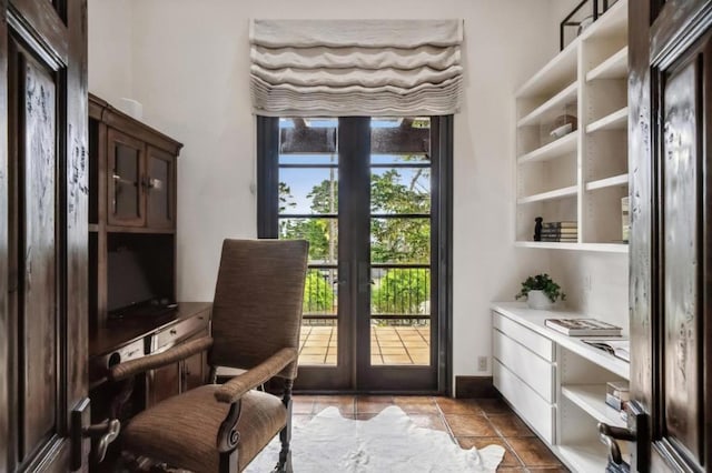 entryway with dark tile patterned floors and french doors