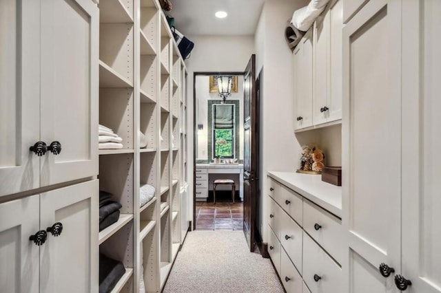 walk in closet with carpet flooring