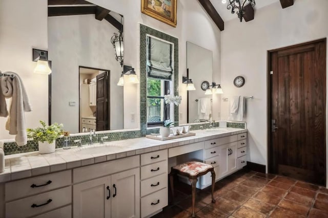 bathroom with high vaulted ceiling, vanity, and beamed ceiling