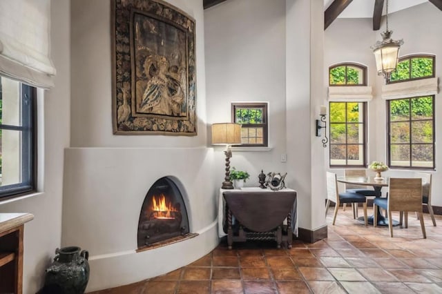 sitting room with beamed ceiling and a high ceiling