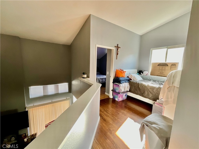 bedroom with wood-type flooring and lofted ceiling