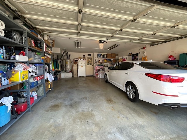 garage with a garage door opener and white fridge