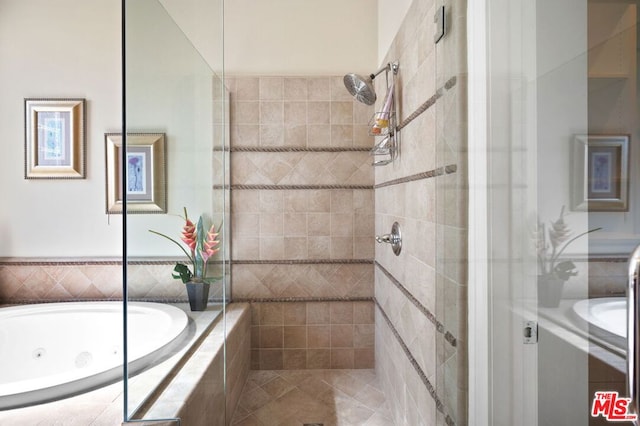 bathroom featuring shower with separate bathtub and tile patterned flooring