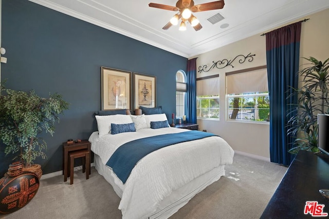 bedroom featuring ceiling fan, light colored carpet, and crown molding