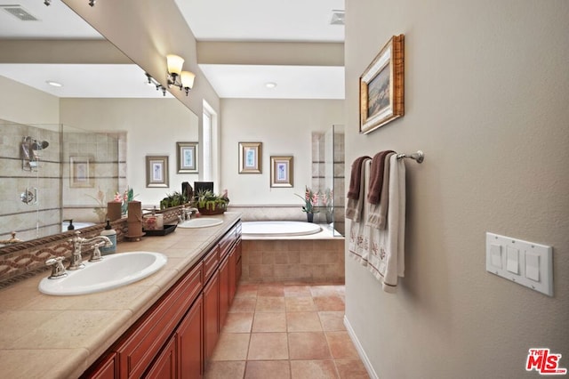 bathroom with independent shower and bath, vanity, and tile patterned floors