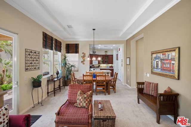 carpeted living room featuring ornamental molding and a wealth of natural light